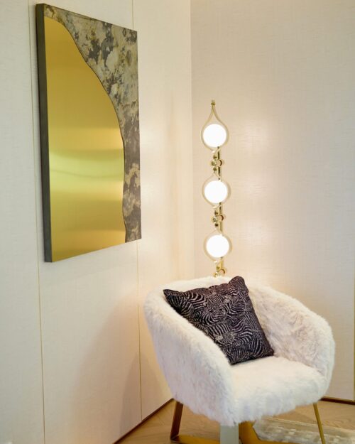 Elegant room design featuring a cozy armchair and modern decor elements.